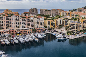 Panoramic view of Fontvieille - district of Monaco with boats and a high-rise apartment complex. Principality of Monaco, French Riviera, Western Europe.