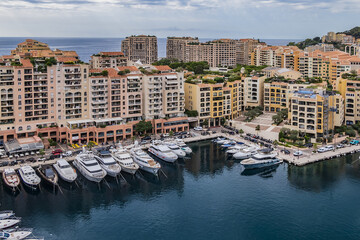 Fototapeta premium Panoramic view of Fontvieille - district of Monaco with boats and a high-rise apartment complex. Principality of Monaco, French Riviera, Western Europe.