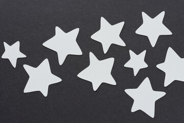 gray paper stars on dark gray paper
