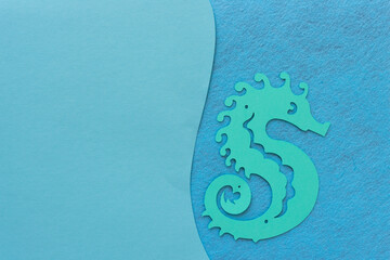 paper seahorse isolated on blue paper and felt