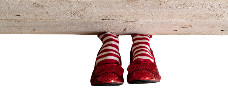 Red and white stripe socks with red ruby slippers isolated under a wood board