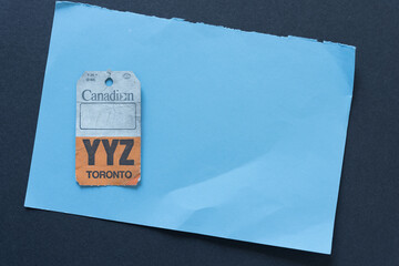 Fototapeta premium old, grungy luggage tag (YYZ, Toronto) on paper