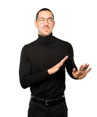 Fototapeta premium Friendly young man doing a gesture of keep calm