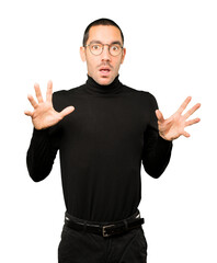 Scared young man screaming against background