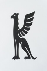 isolated mythological creature glyph (griffon) on blank paper