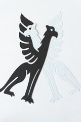 two mythological creature glyphs (griffons) on blank paper