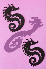 paper card seahorse and dragon on pink felt