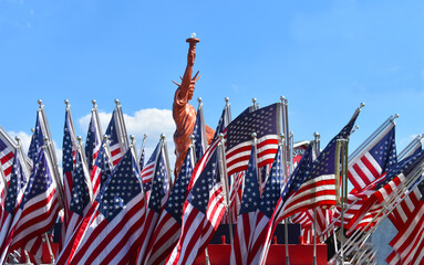 USA American Flags with the Stature of Liberty Statue