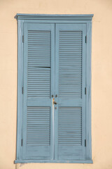 Light blue wooden window against the beige wall at downtown Tucson, Arizona