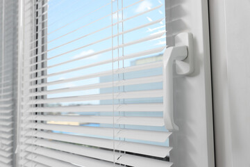 Window with horizontal blinds indoors, closeup view