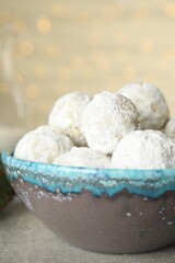 Fototapeta na wymiar Tasty snowball cookies in bowl, closeup. Christmas treat