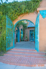 Downtown Tucson, Arizona- Arch entrance with bricks stairs and painted blue iron gate