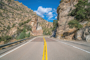 Mount Lemmon, Arizona- Highway with metal barriers in between the rocky mountain walls