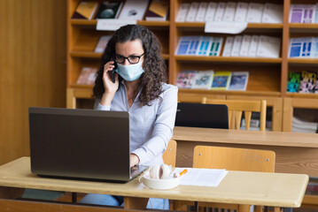 Young woman student study in the library using laptop