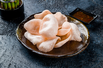 Vietnamese shrimp chips on dark stone table - 529732817