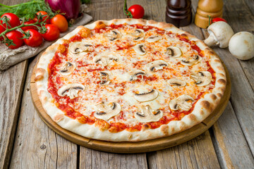 pizza with mushrooms, cheese and tomato sauce on wooden table close up - 529732893