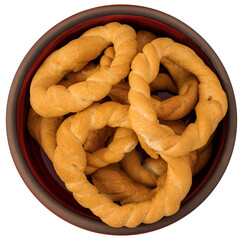 Pieces of traditional Latin American pastry called ROSQUITAS DE SAL or ROSCAS made with wheat flour. Top view of Neapolitan cookies called TARALLI. Stale salt bagels. Wood table. Ecuador