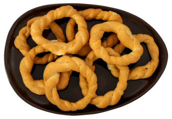 Pieces of traditional Latin American pastry called ROSQUITAS DE SAL or ROSCAS made with wheat flour. Top view of Neapolitan cookies called TARALLI. Stale salt bagels. Wood table. Ecuador
