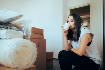 Woman Having a Coffee After Packing all her Belonging for Relocation. Person trying to rest and de-stress before unpacking all her stuff in new location
