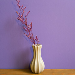 Vase of dry flowers on wooden table. purple wall background. retro style. home interior
