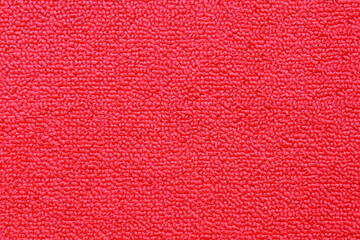 Bright red seamless generic carpet texture shot from above texture background