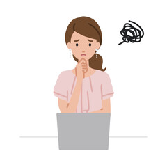 デスクで座ってPCを開いて困っているオフィスカジュアルの女性