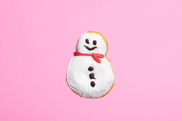 Snowman donut isolated on pink background. Christmas and sweet food concept.