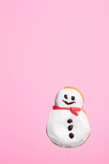 Snowman donut isolated on pink background. Christmas and sweet food concept.