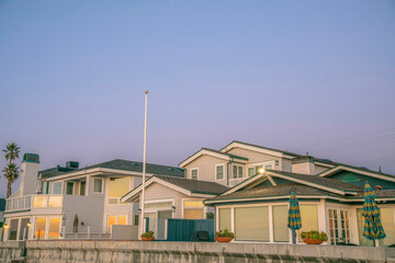 La Jolla, California- Row of houses with sunset glow on glass panes against the dark sky background