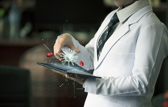 Woman doctor holding hand on device with holographic virus and red blood cell - Powered by Adobe