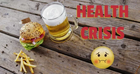 Gordijnen Health Crisis text and  Nauseated Face Emoji against beer, burger and fries on wooden surface © vectorfusionart