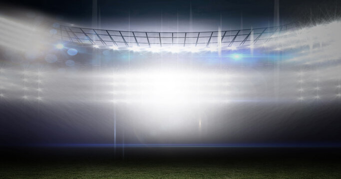 Image of blurred moving lights and bokeh light spots at floodlit sports stadium