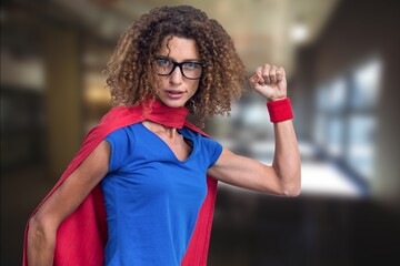 Composite image of african american woman in superhero costume against empty office in background
