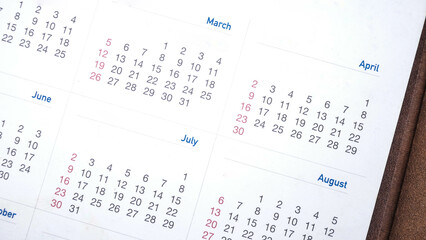 White calendar on brown lather.