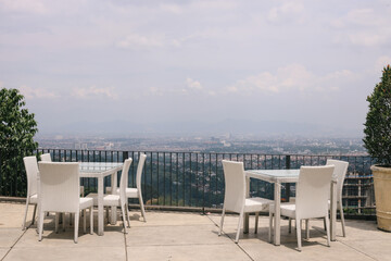 Rooftop cafe, open terrace with rattan tables and chairs