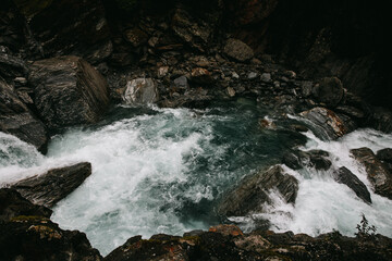 A stoney river runs through a valley in New Zealand
