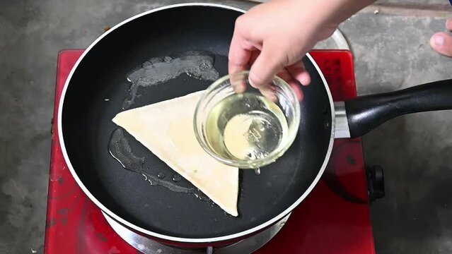 Making bread in fry-pen or pide dough by close up female hands in pastry kitchen. Slow motion video