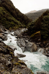 Obraz premium A stoney river runs through a valley in New Zealand