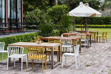 Table sets in outdoor cafes in green garden outside restaurant