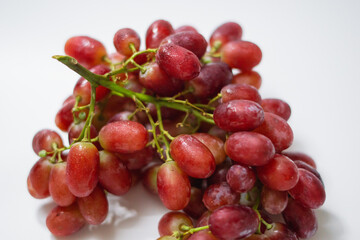 Obraz premium 1 bunch of red ripe grapes on a white background