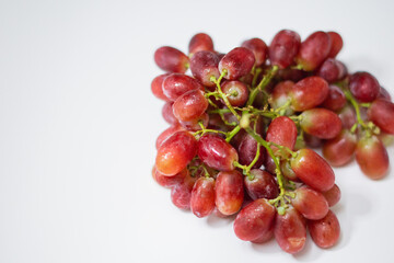 1 bunch of red ripe grapes on a white background