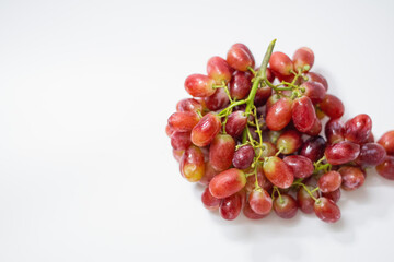 1 bunch of red ripe grapes on a white background