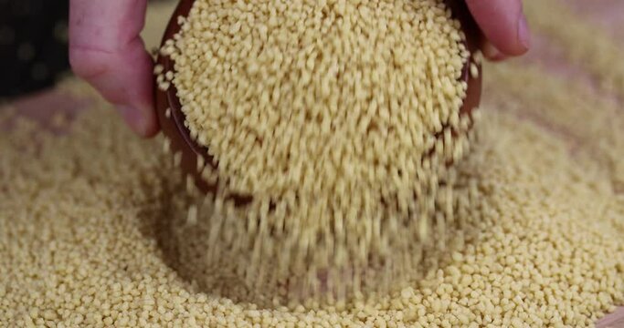 Sprinkle porridge couscous from wheat or millet, cooking dishes from traditional grits of crushed yellow couscous