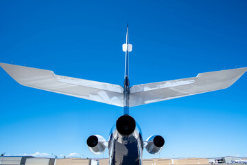 Private Jet Airplane Parked on Tarmac Under Clear Blue Sky During Daytime