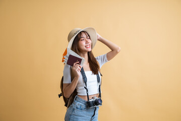 young attractive Asian woman traveler in casual clothes wearing straw hat with backpack, passport, camera and boarding pass ticket, Tourist girl having cheerful holiday trip concept