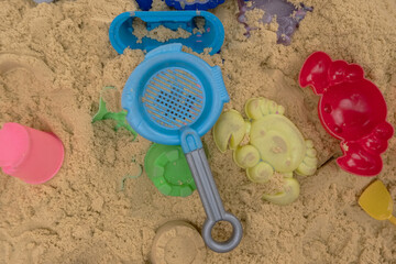 Children's sandbox with plastic toys, concept of summer games in the sand