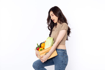 Cheerful smiling Asian woman holding a wooden box of vegetables after shopping isolated on a white background