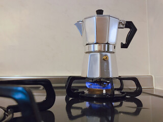 Moka pot brewing coffee on a stove