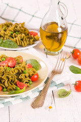 Fusilli pasta with cherry tomatoes and peas.
