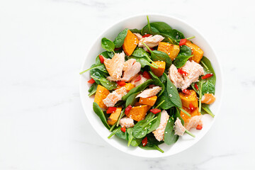 Spinach, salmon and sweetpotato festive thansgiving salad with pomegranate, top view